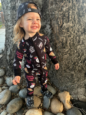 toddler girl wearing pop punk collage pattern long sleeve zip up bamboo pajamas for kids