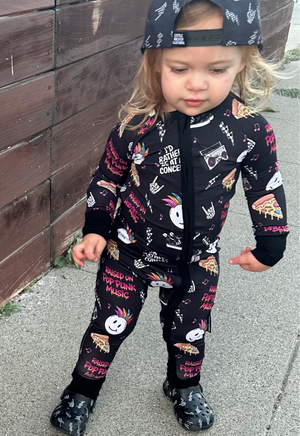 toddler wearing pop punk collage pattern long sleeve zip up bamboo pajamas for kids