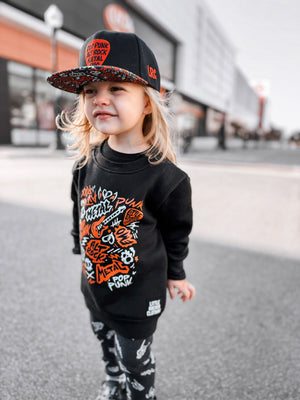 Toddler girl wearing the scene sampler crew neck sweatshirt for kids and adults with pop punk alt rock metal emo graphic design, rocker style apparel, little rocker clothing