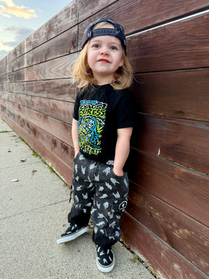 kids outfit featuring black washed baggy jeans with skull pattern edgy kids clothing and rock kids clothing style
