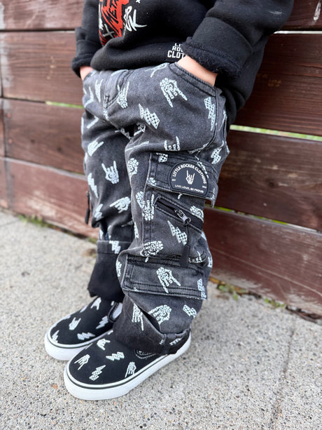 kids wearing black washed baggy jeans with skull pattern styled as edgy kids outfit from Little Rocker Clothing