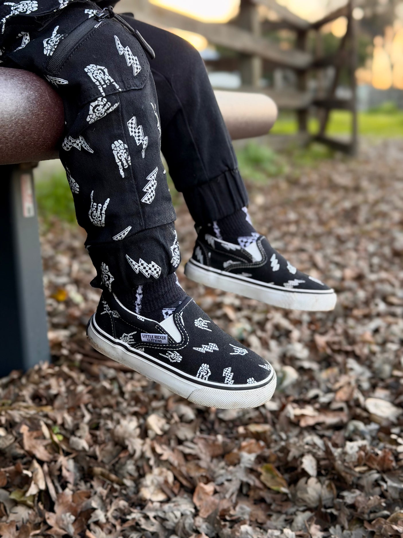 bolted bones canvas slip on shoes for kids with black and white skull and lightening bolt pattern, rocker style kids sneakers, elastic slip on design, little rocker clothing footwear
