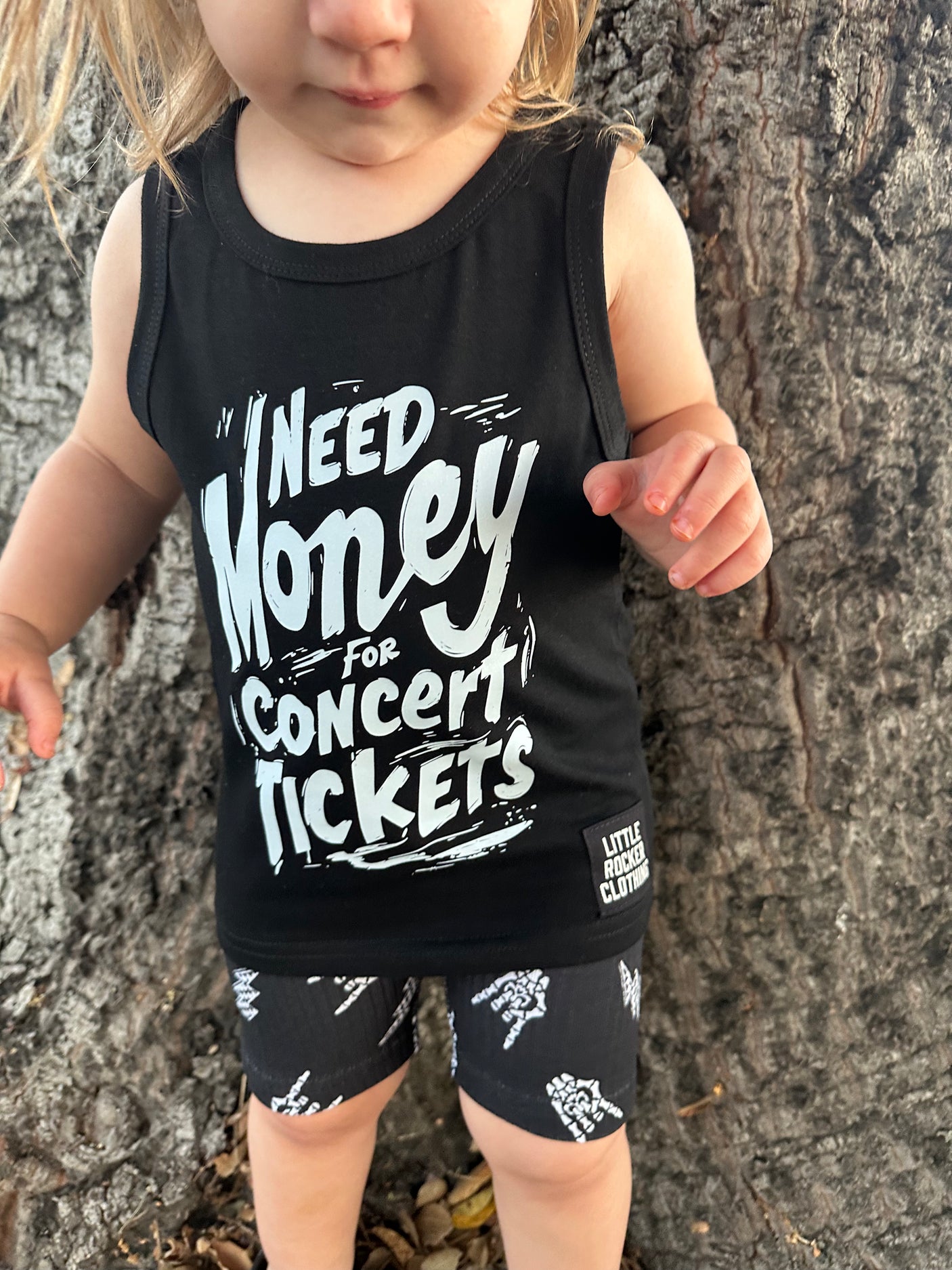 close up of kids graphic tank top that says need money for concert tickets black rocker style sleeveless shirt for kids summer outfit sizes toddler to youth