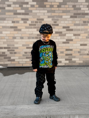 Lifestyle image of Kids black Scene Sampler crew neck sweatshirt featuring pop punk, emo, and alt rock graphic with train illustration, rocker style kids apparel