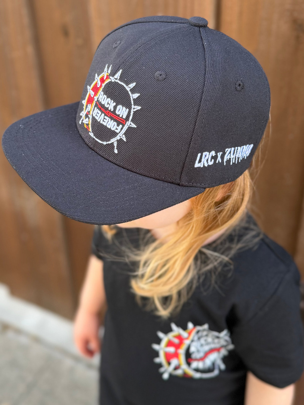 Frank Zummo collaboration with Little Rocker Clothing snapback hat with drum graphic and rock on forever phrase, edgy rock style kids hat with adjustable fit, music inspired youth apparel accessory