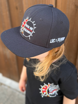 Frank Zummo collaboration with Little Rocker Clothing snapback hat with drum graphic and rock on forever phrase, edgy rock style kids hat with adjustable fit, music inspired youth apparel accessory