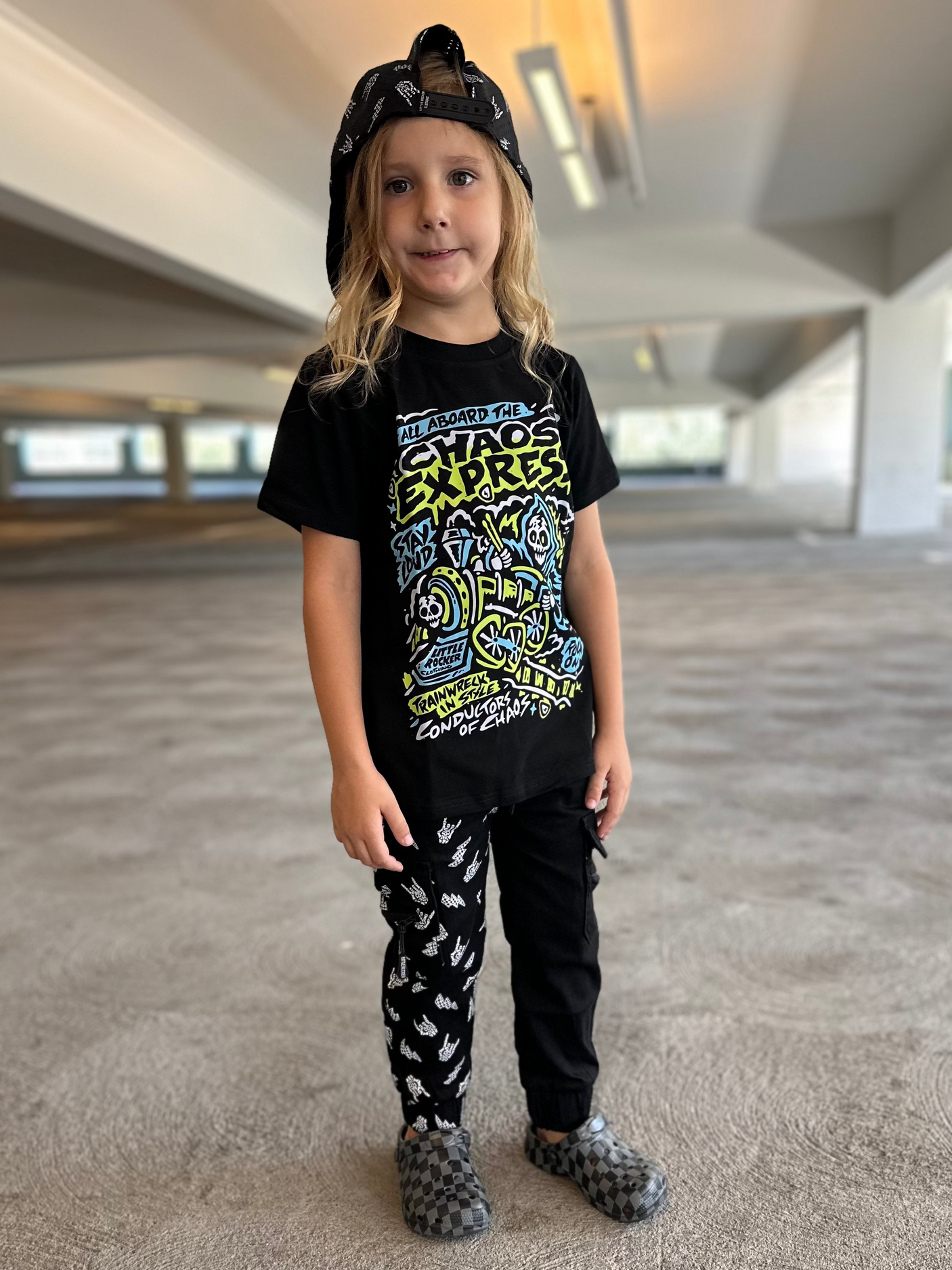 Preteen wearing the Kids black chaos express t-shirt featuring rock inspired graphic with train illustration on a graphic tee, rocker style kids apparel