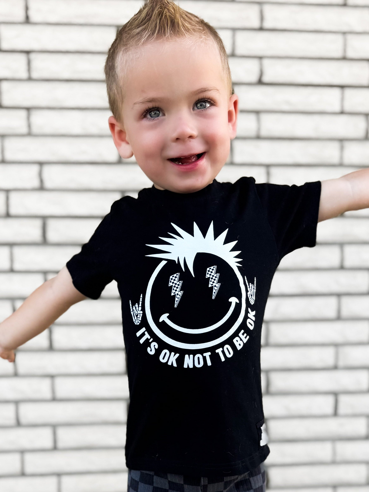 toddler boy wearing black kids graphic t-shirt with it's okay to not be okay, mental health awareness, little rocker clothing rock style outfit 