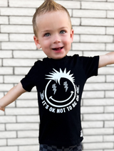 toddler boy wearing black kids graphic t-shirt with it's okay to not be okay, mental health awareness, little rocker clothing rock style outfit 