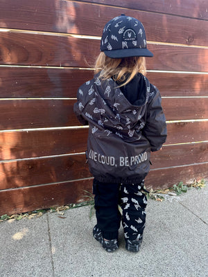 Back side of Kids bolted bones black windbreaker jacket with all over graphic print, lightweight rocker style outerwear for kids with zip front and hood