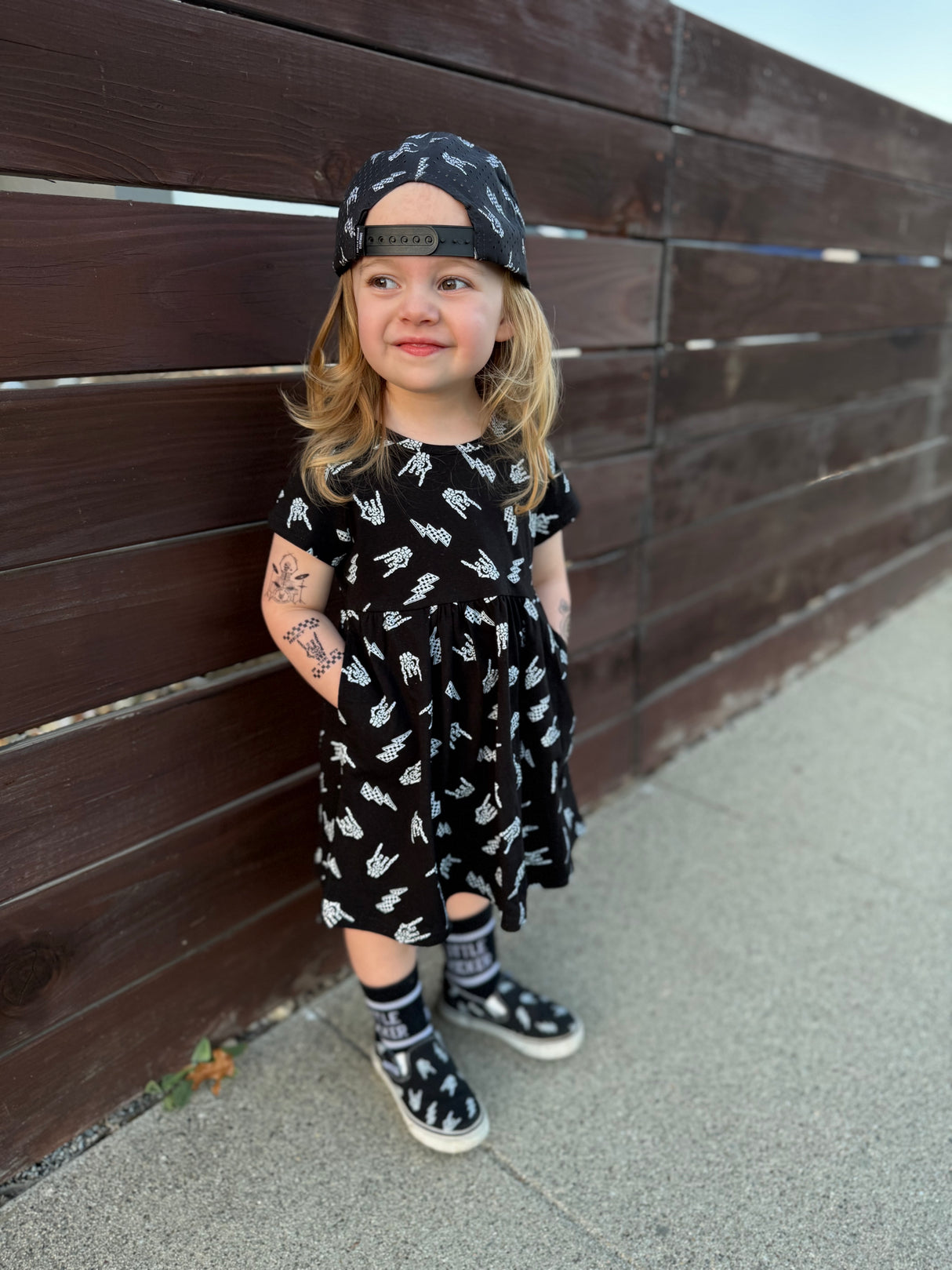 black bolted bones dress for toddlers with skull pattern styled as edgy kids outfit and rock kids clothing look