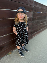 black bolted bones dress for toddlers with skull pattern styled as edgy kids outfit and rock kids clothing look