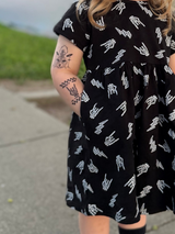 close up of black dress with skeleton hand horns and lightening bolt pattern