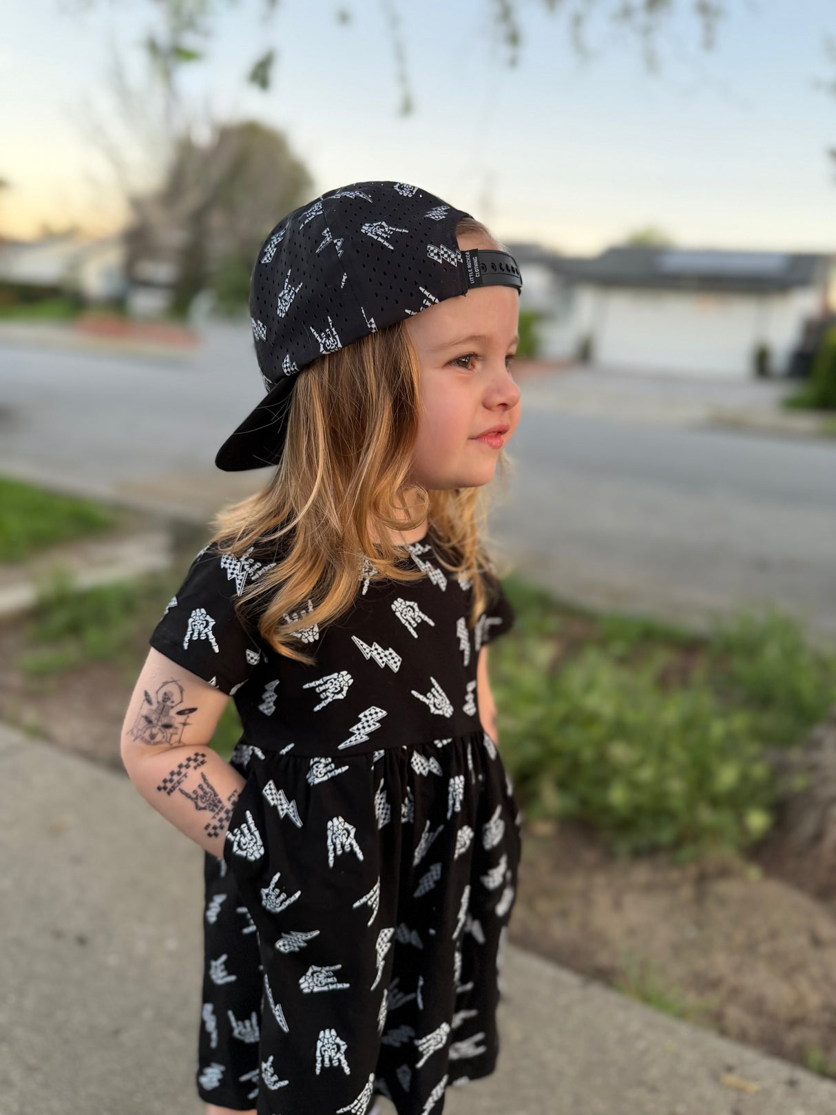 close up of young girl wearing bolted bones pattern black dress
