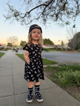 young girl wearing bolted bones pattern black dress