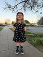 toddler wearing black bolted bones dress with skull print from Little Rocker Clothing alternative kids clothing edgy kids outfit