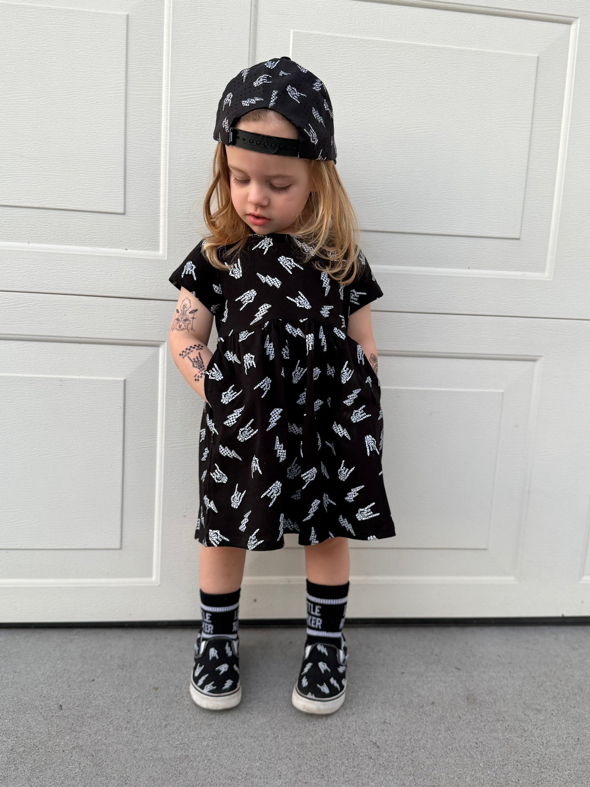 edgy toddler outfit with black skull print dress with pockets from Little Rocker Clothing alternative kids fashion and rock style clothing