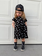 edgy toddler outfit with black skull print dress with pockets from Little Rocker Clothing alternative kids fashion and rock style clothing