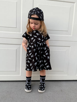 edgy toddler outfit with black skull print dress with pockets from Little Rocker Clothing alternative kids fashion and rock style clothing