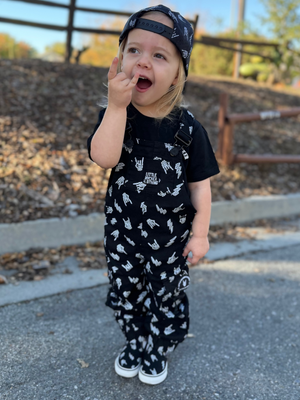 toddler girl wearing kids black bolted bones overalls with lightning bolt and rock hand print matching outfits toddler streetwear little rocker clothing