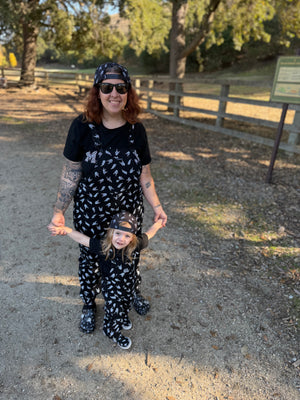 black bolted bones overalls for adults shown with matching kids outfit styled for edgy outfits and everyday wear