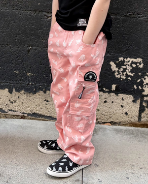 kid wearing pink straight leg jeans with hands in the pockets