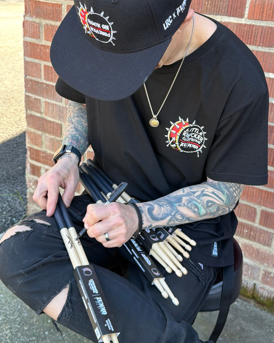 Frank Zummo Autographing little rocker clothing drumsticks