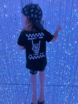 girl wearing meet me in the pit rock inspired outfit in a mirror maze 